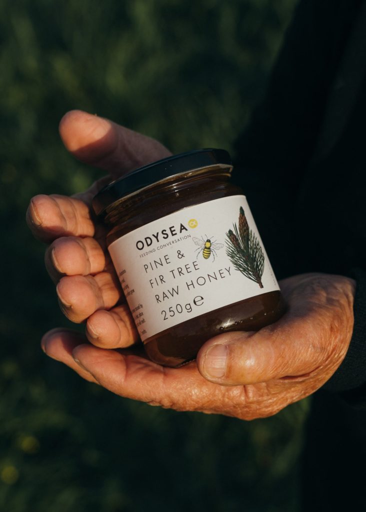 Raw Honey held by producer hands